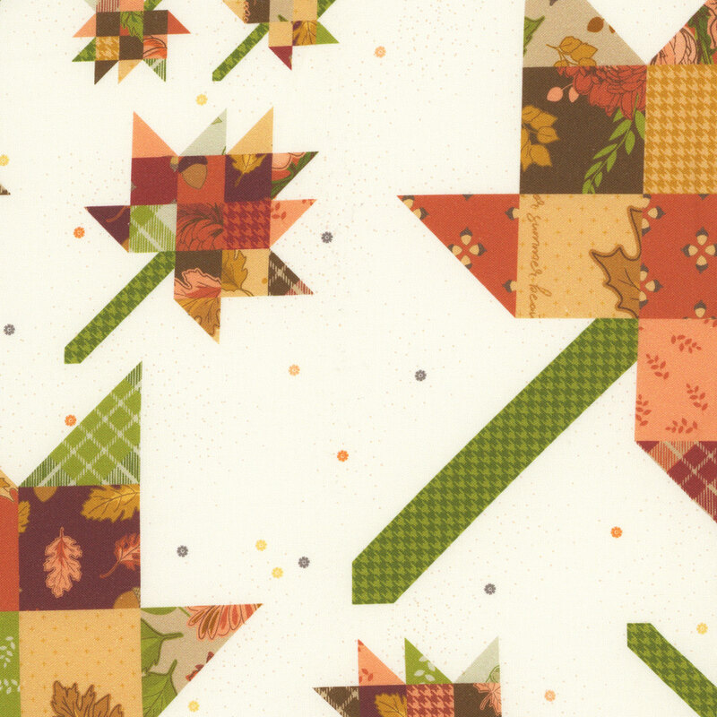 An off white fabric swatch featuring a pieced design with multiple patterns in autumn toned hues.
