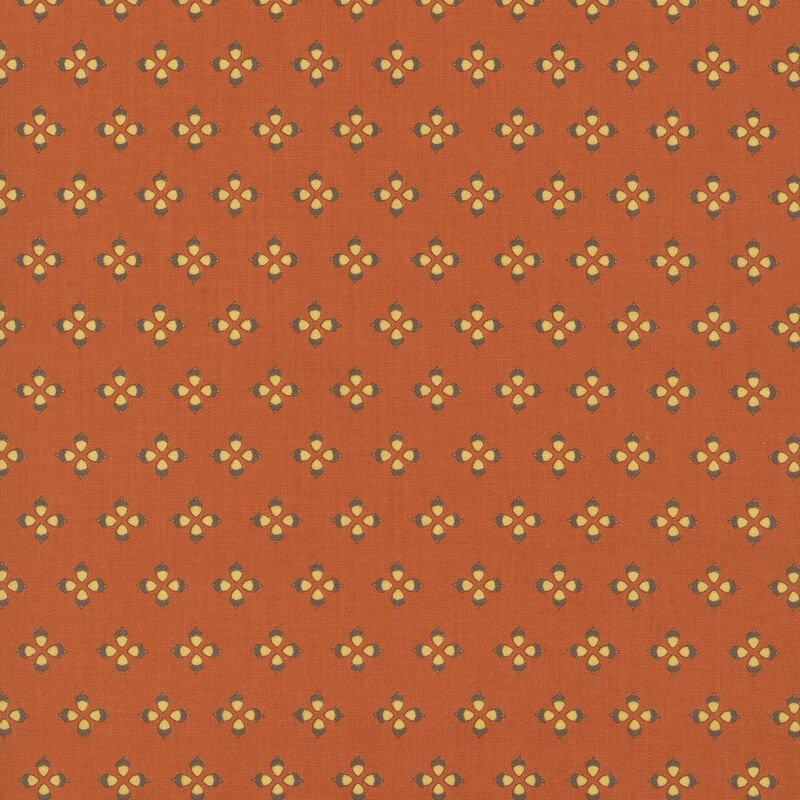 A rusty red fabric swatch featuring a featuring a geometric acorn pattern.