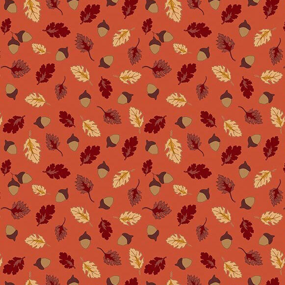 A rusty red fabric swatch featuring a pattern of tossed acorns and leaves.