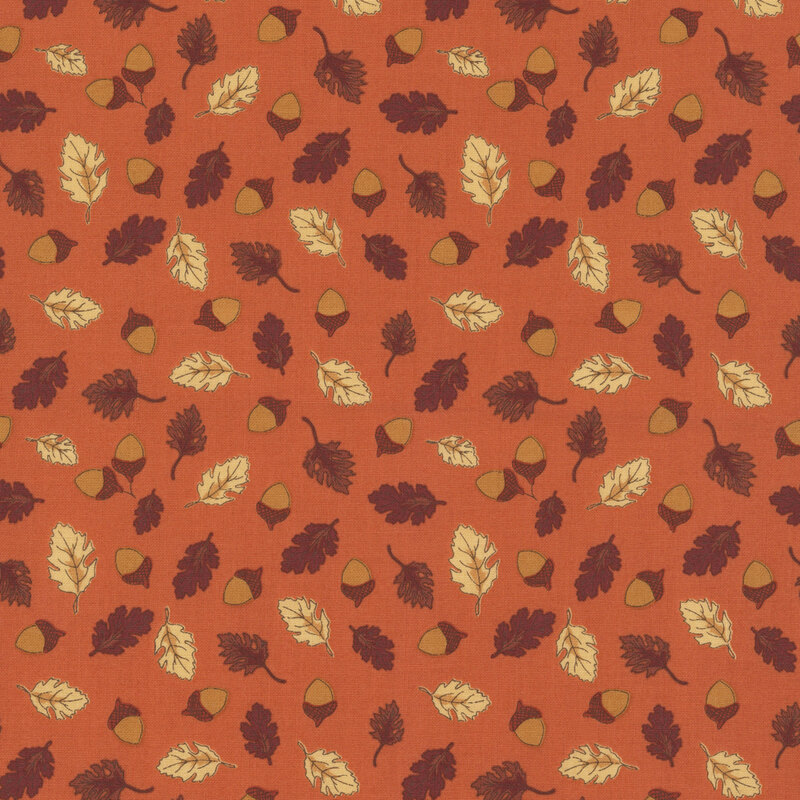 A rusty red fabric swatch featuring a pattern of tossed acorns and leaves.