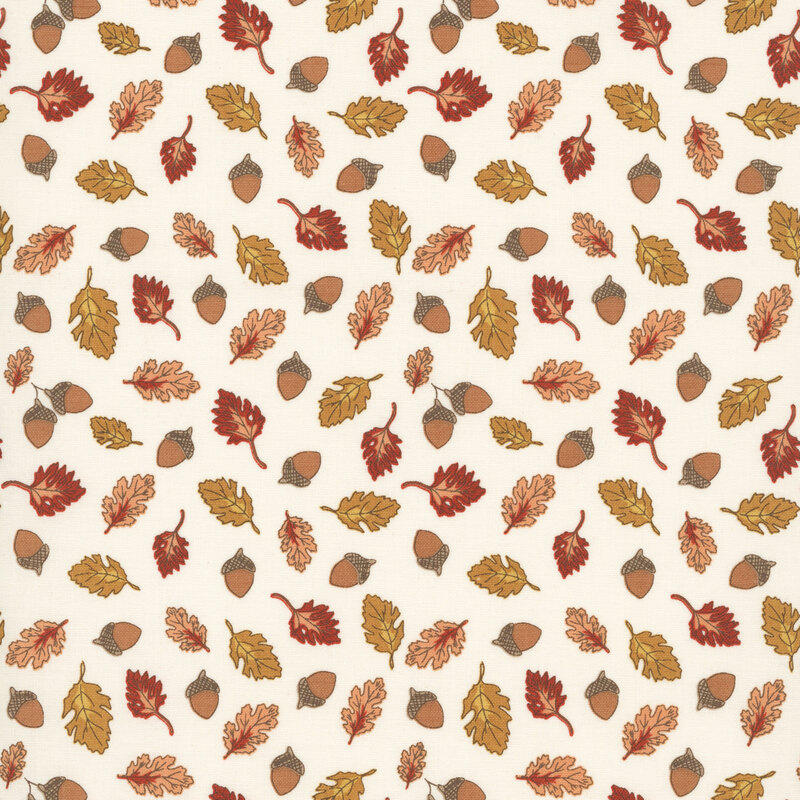A cream fabric swatch featuring a pattern of tossed acorns and leaves.