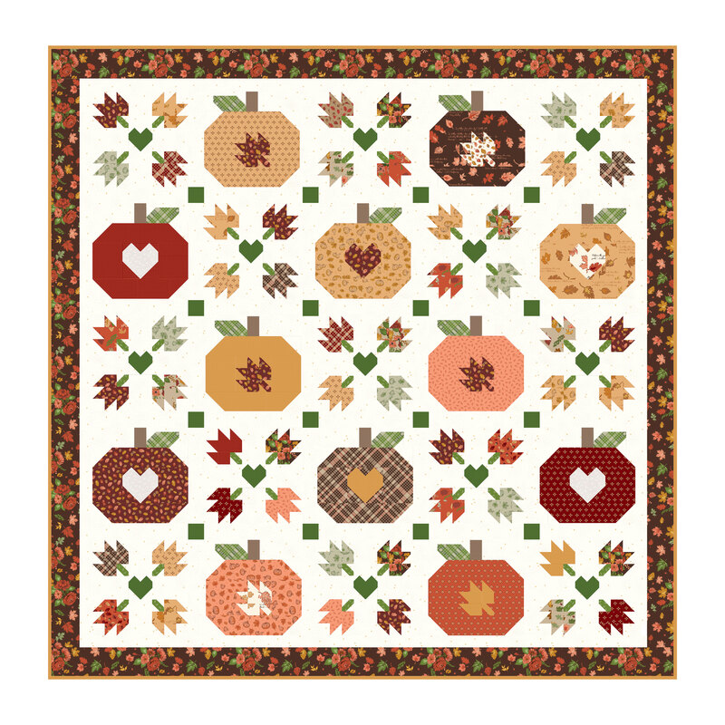 Image of the Cozy Autumn quilt featuring patchwork pumpkins, falling leaves, and hearts.