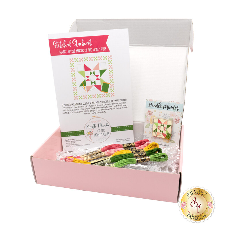The open March kit, a pink box containing colorful embroidery threads, a project guide, and a small pattern card.