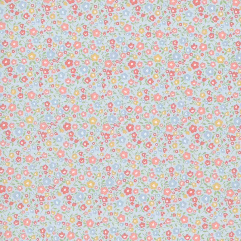 Baby blue fabric with a calico pattern of pastel coral, peach, blue and yellow flowers.