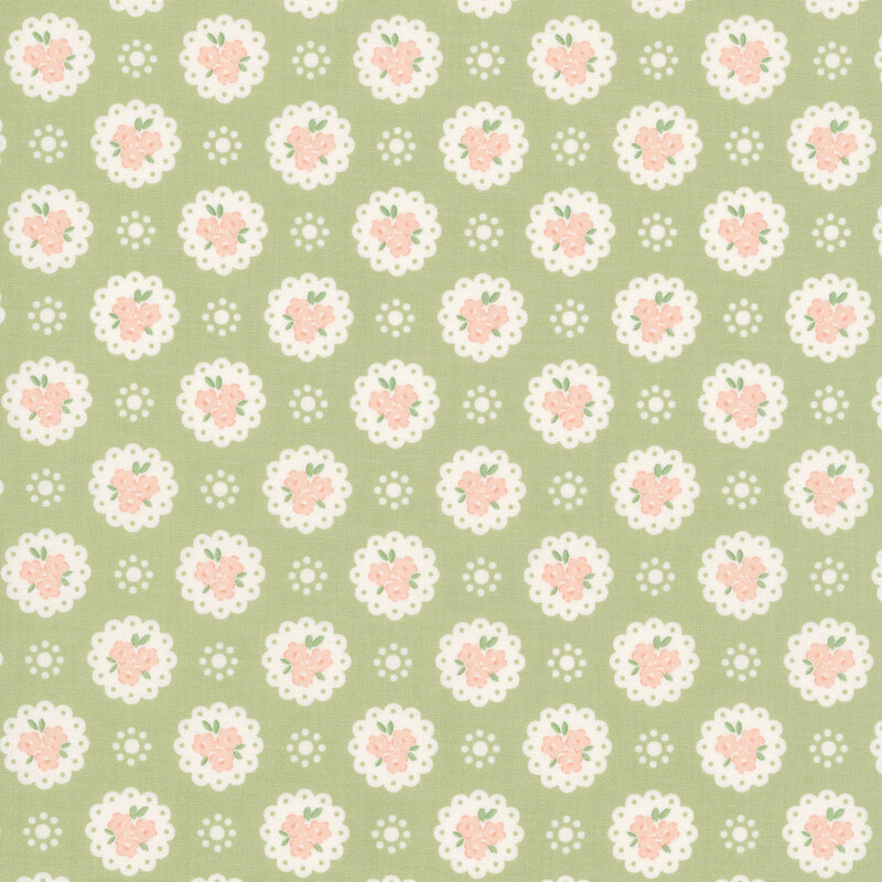 Pear green fabric with a pattern of white doilies containing light peach flowers and white dots
