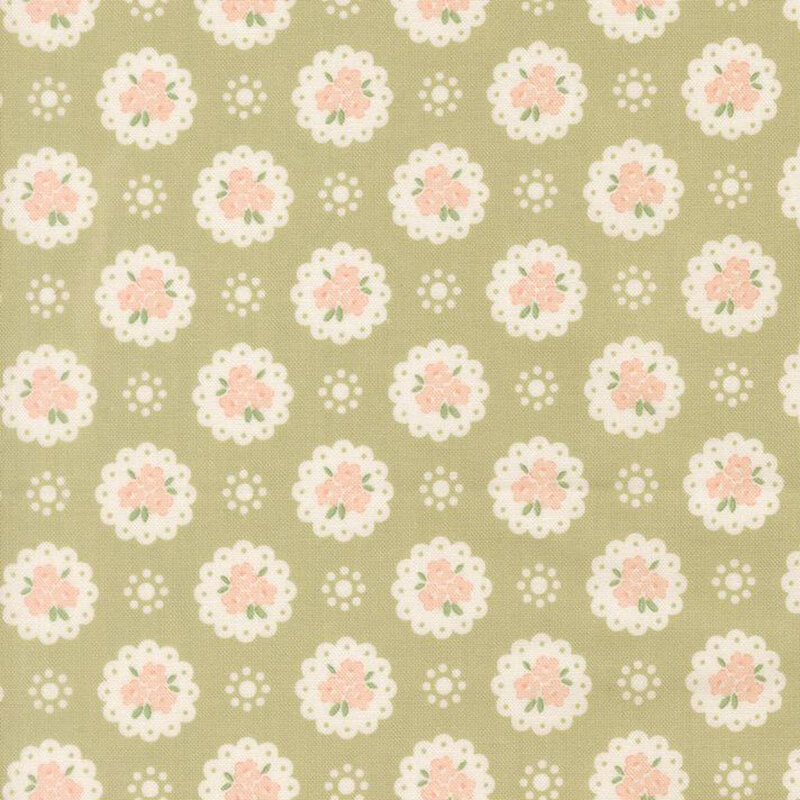 Pear green fabric with a pattern of white doilies containing light peach flowers and white dots
