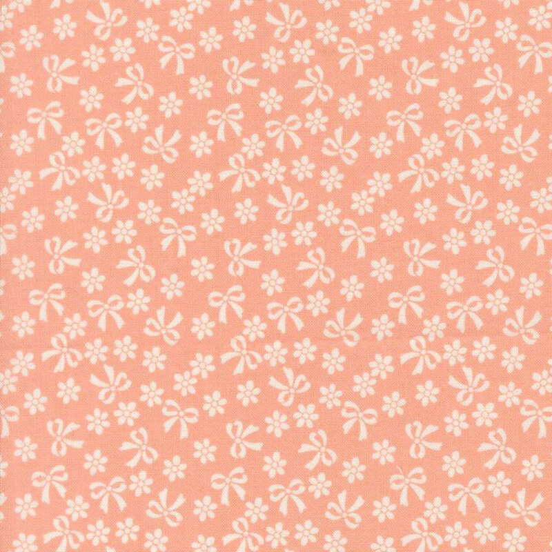 Peach fabric with cream bows and flowers.