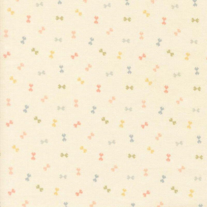 Cream fabric with a ditsy pattern of peach, yellow, green, and blue bowtie shapes