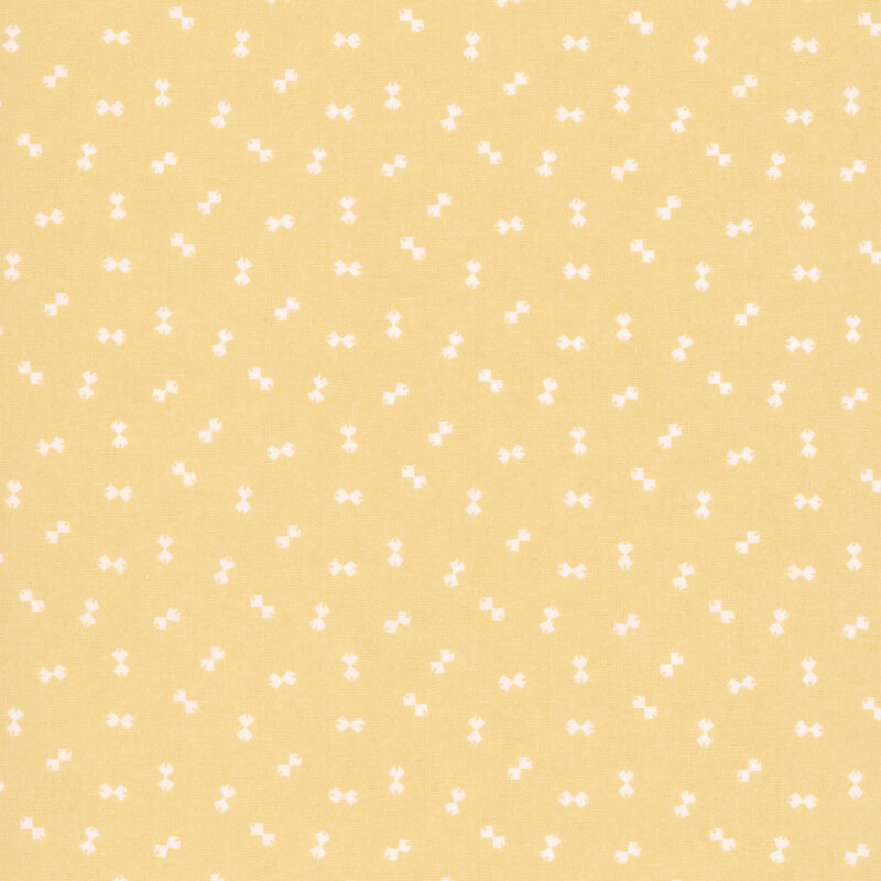 Bright yellow fabric with a ditsy pattern of cream bowtie shapes