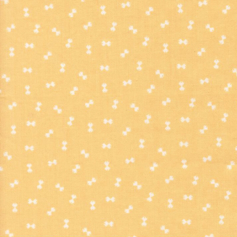 Bright yellow fabric with a ditsy pattern of cream bowtie shapes