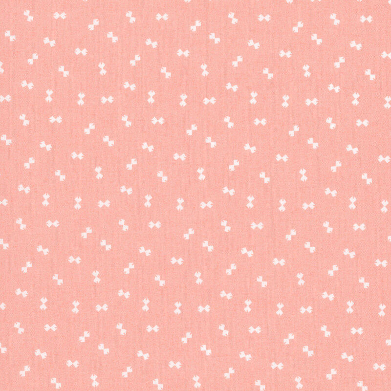 Peach fabric with a ditsy pattern of white bowtie shapes.