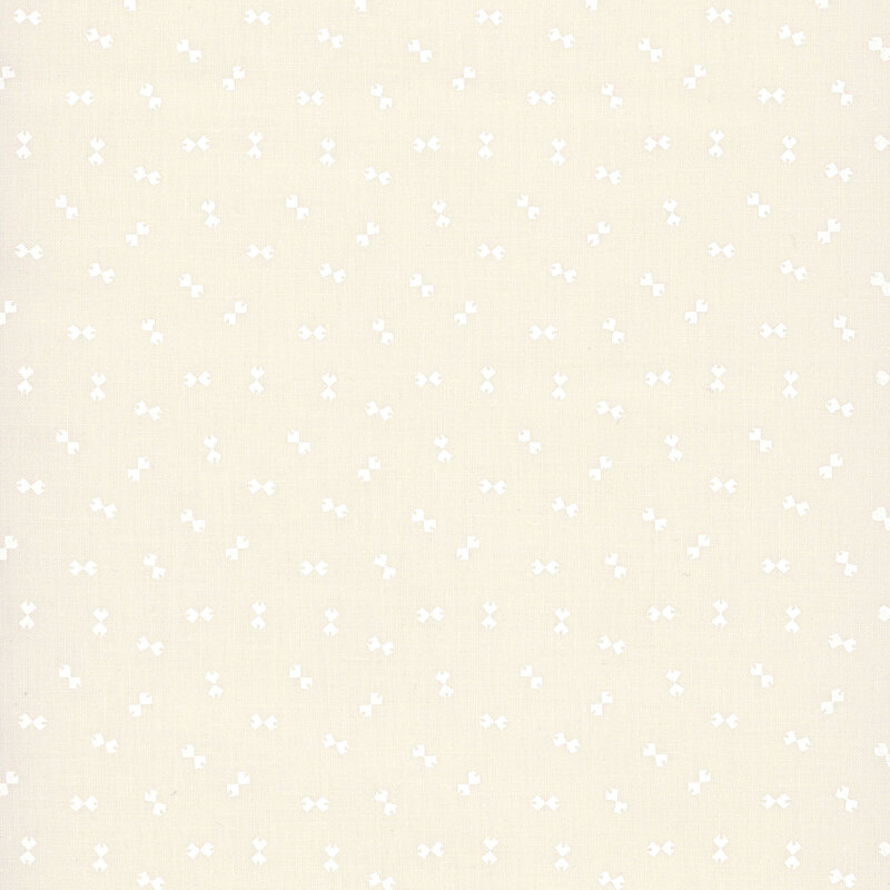 Cream fabric with a ditsy pattern of white bowtie shapes