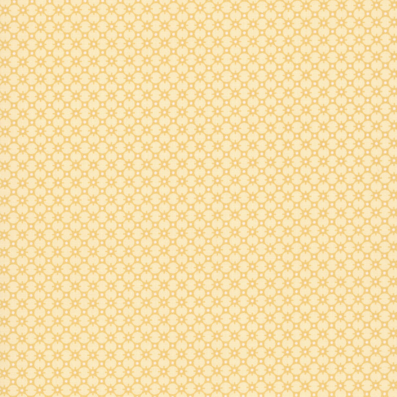 Yellow fabric with a gold pattern of circles and white dots