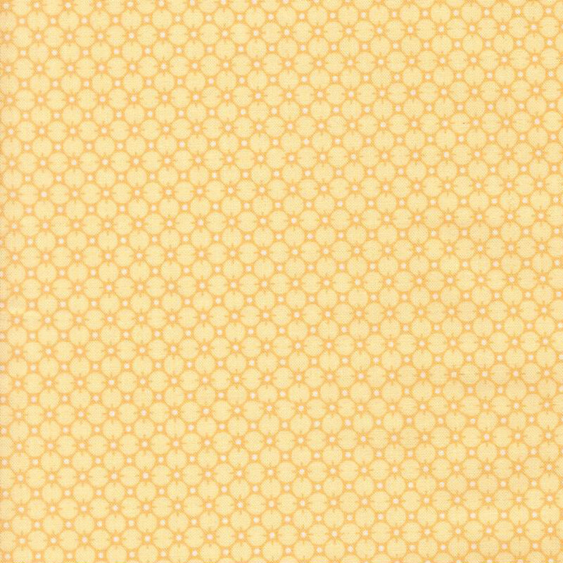 Yellow fabric with a gold pattern of circles and white dots