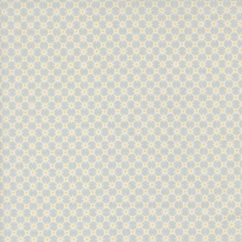Baby blue fabric with a cream pattern of circles and gold dots