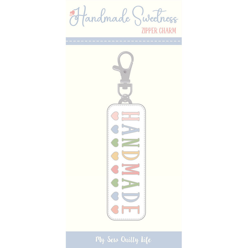 Digital mockup of the zipper charm, which features the word "HANDMADE" in colorful letters and hearts across the bottom, with a silver metal clasp