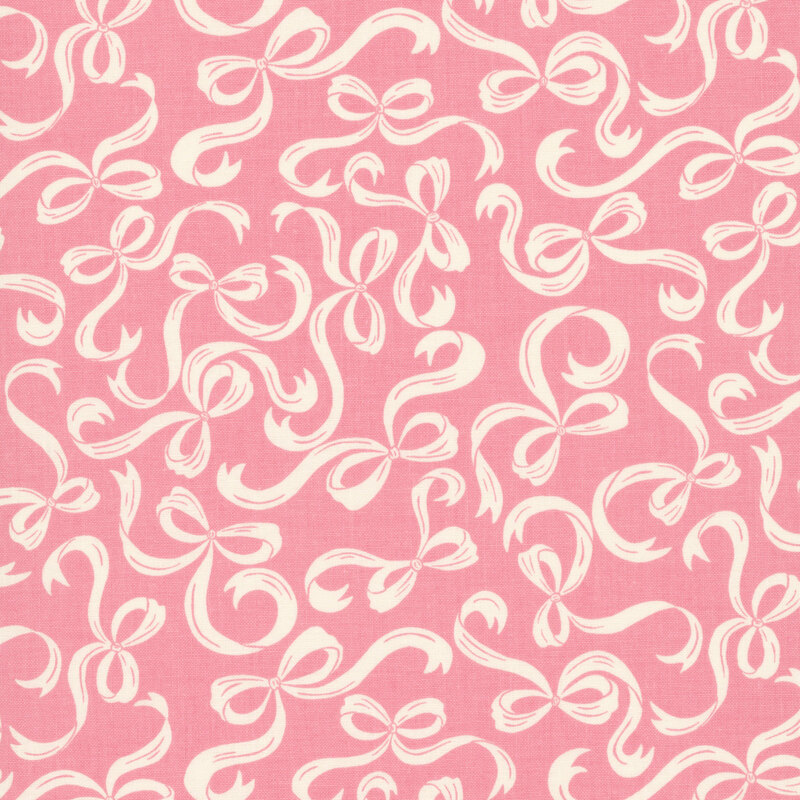 Coral pink fabric with a pattern of swirling cream bows