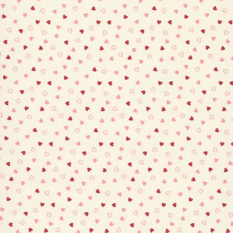 Tossed pink and red hearts on a beige background