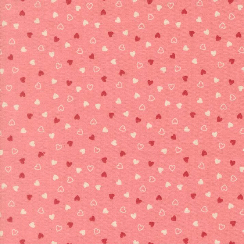 Tossed red and cream hearts on a coral pink background