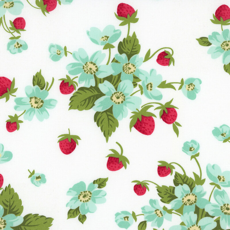 A white fabric with bunches of strawberry plants with blue flowers. 