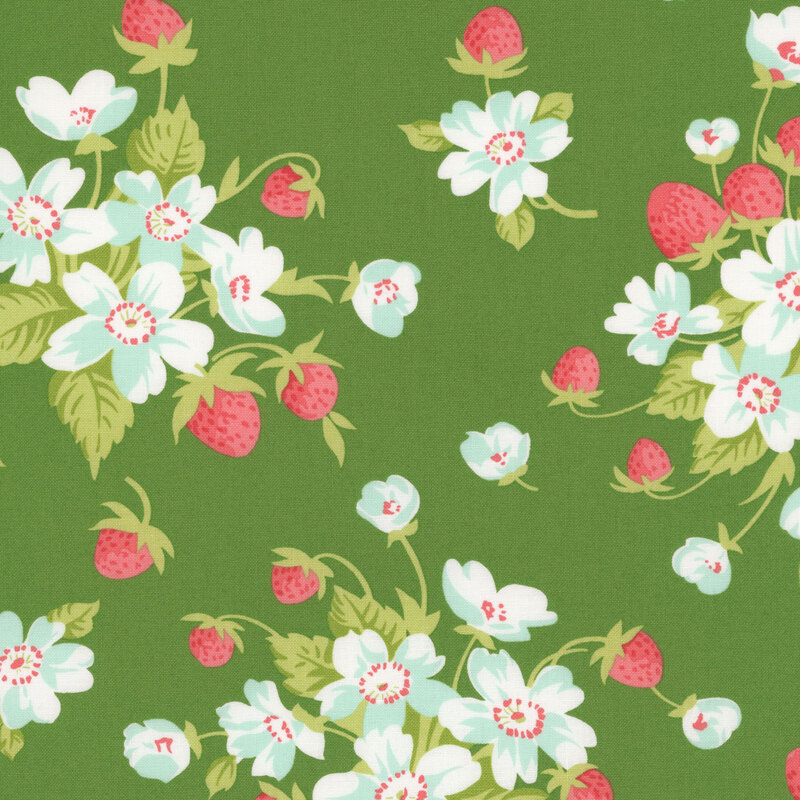 A green fabric with bunches of strawberry plants with blue flowers. 