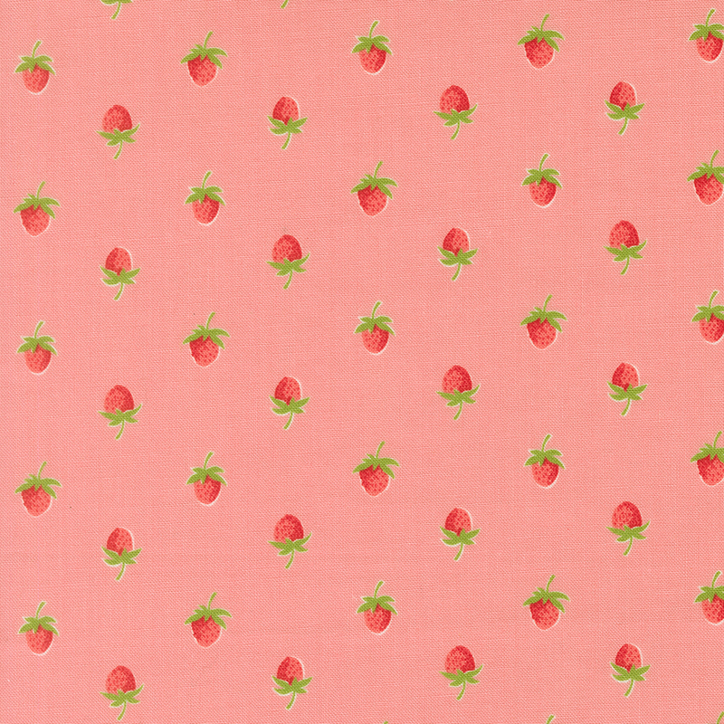 A coral pink fabric with a half drop pattern of red strawberries. 