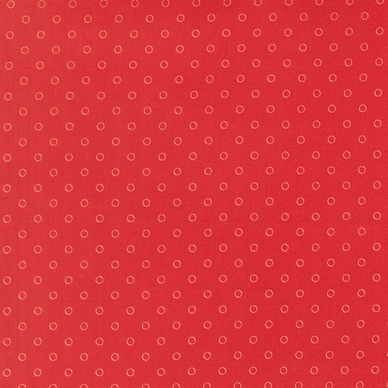 A ruby red fabric with polka dots in a half drop pattern. 