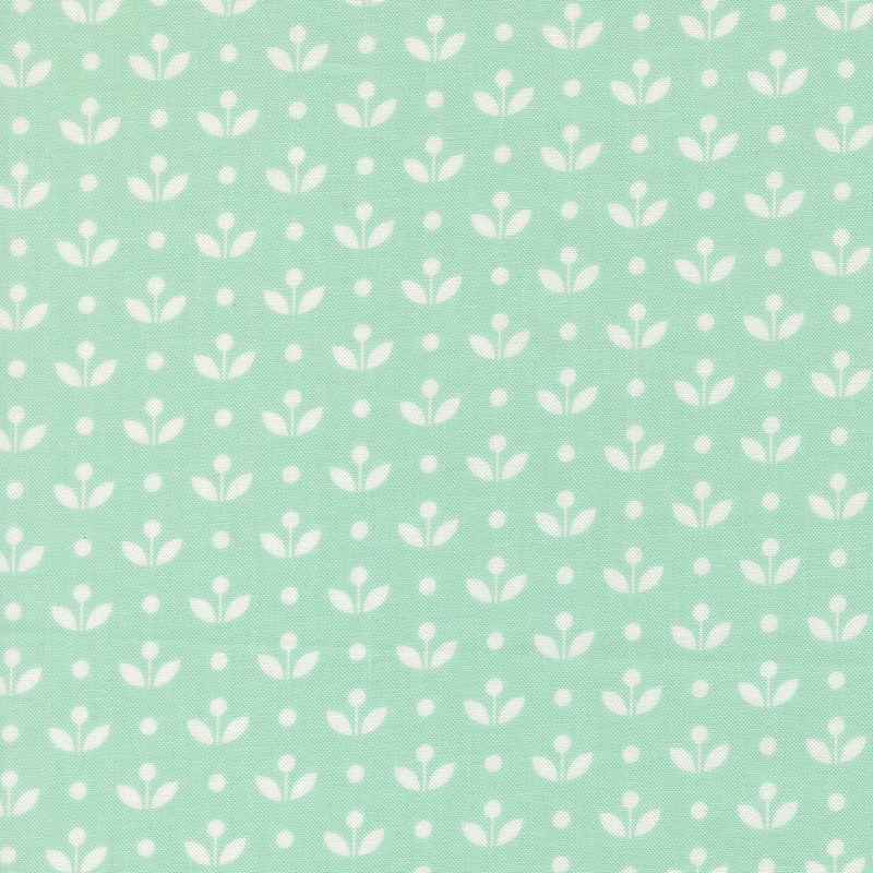 A aqua fabric with vintage inspired flowers with white polka dots. 