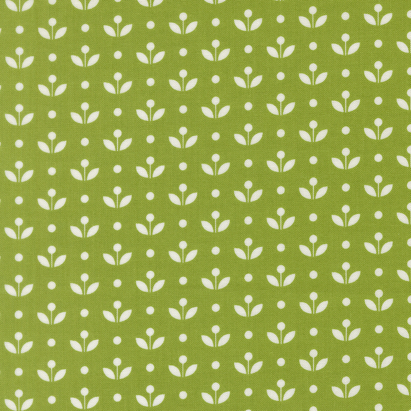 A grass green fabric with vintage inspired flowers with white polka dots. 