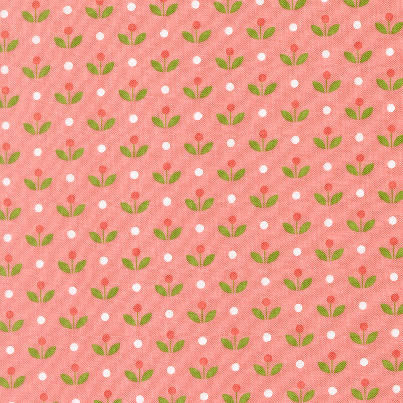 A coral pink fabric with vintage inspired flowers with white polka dots. 