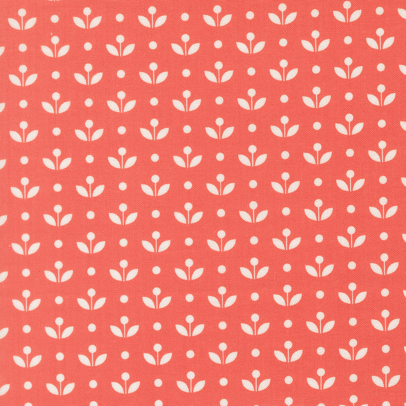 A watermelon red fabric with vintage inspired flowers with white polka dots. 