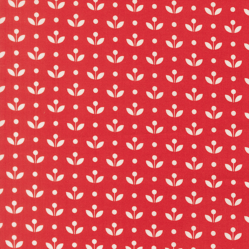 A ruby red fabric with vintage inspired flowers with white polka dots. 