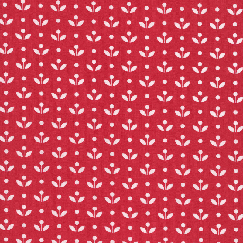 A ruby red fabric with vintage inspired flowers with white polka dots. 