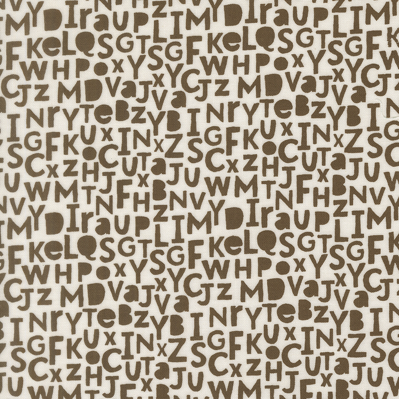 A light palomino fabric swatch featuring brown alphabet letters.