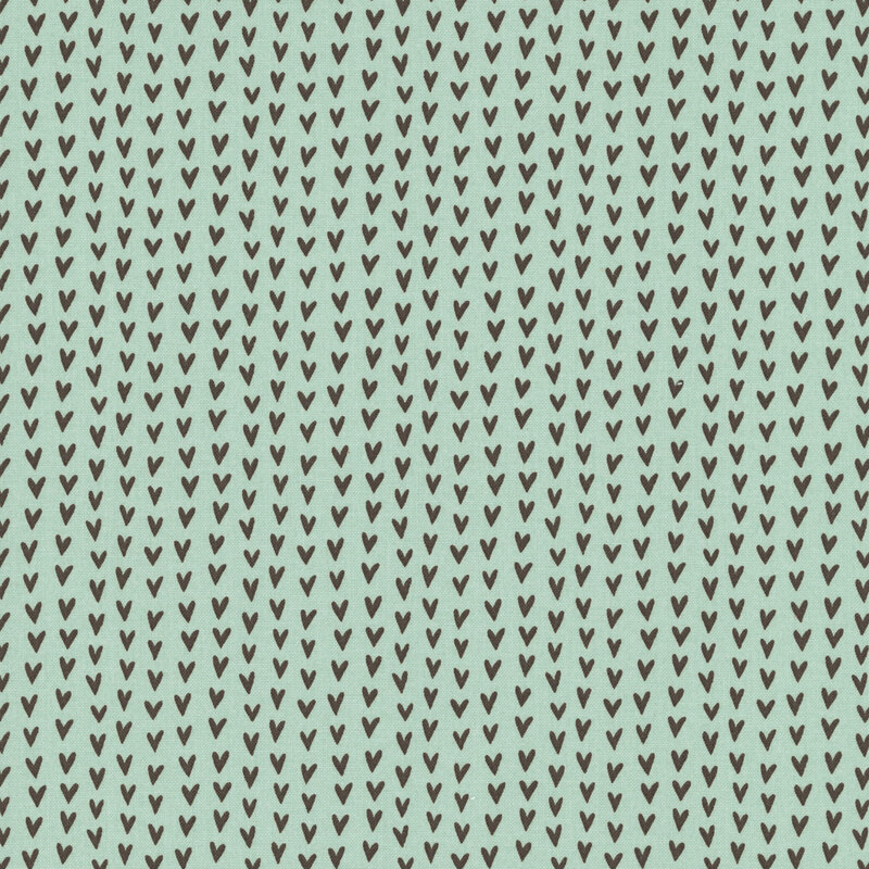 An aqua colored fabric swatch featuring rows of brown hearts.