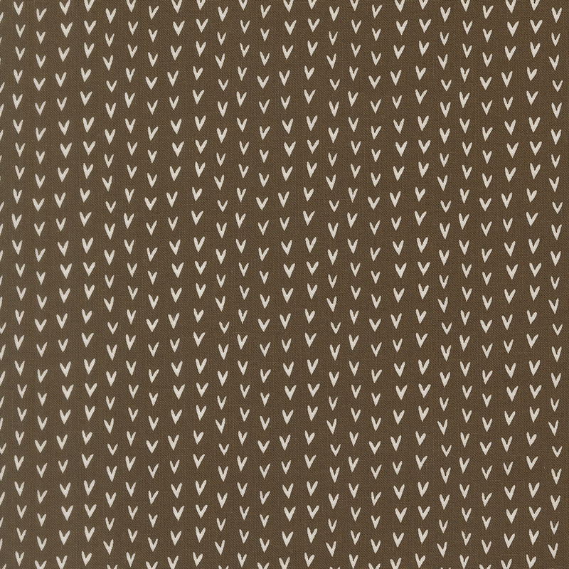 A brown fabric swatch featuring rows of off white hearts.