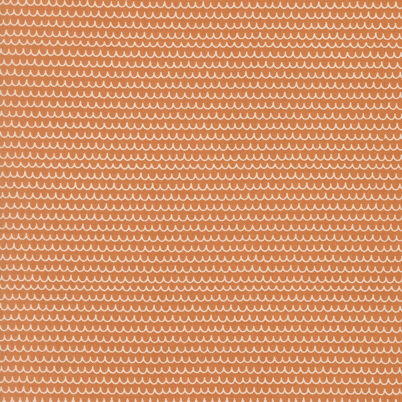 An orange fabric featuring white scalloped lines.