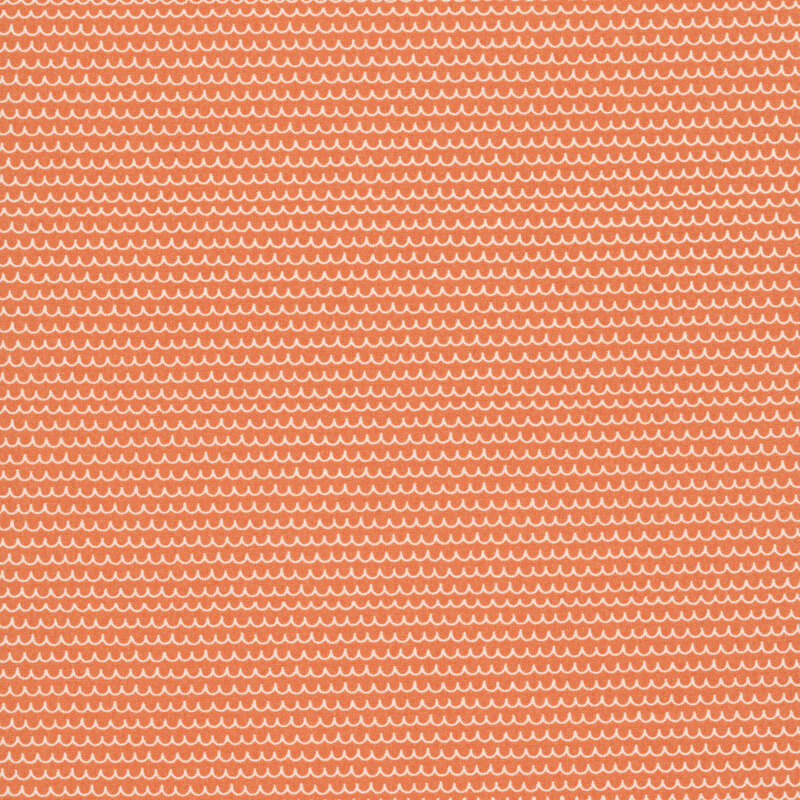 An orange fabric featuring white scalloped lines.