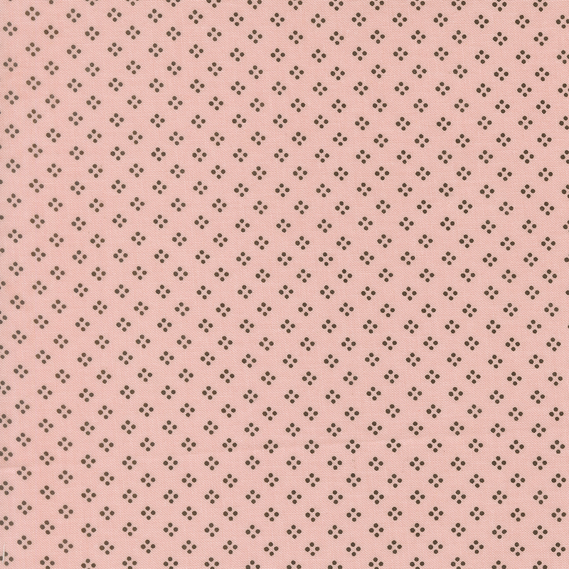 A rose pink fabric featuring a dotted geometric pattern in brown.