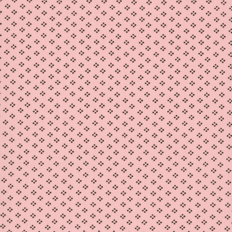 A rose pink fabric featuring a dotted geometric pattern in brown.