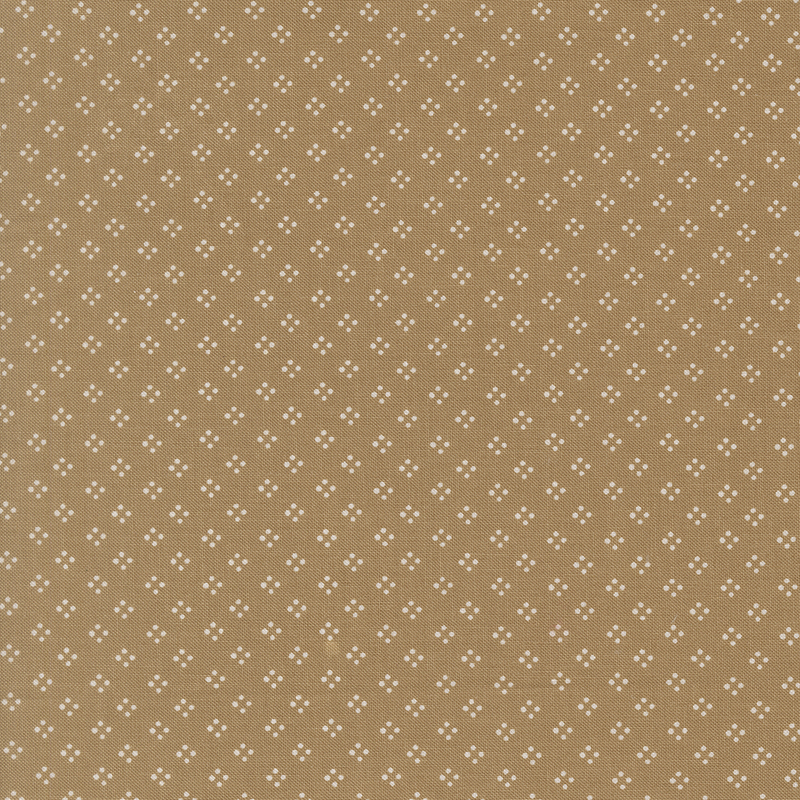 A tan fabric featuring a dotted geometric pattern in white.