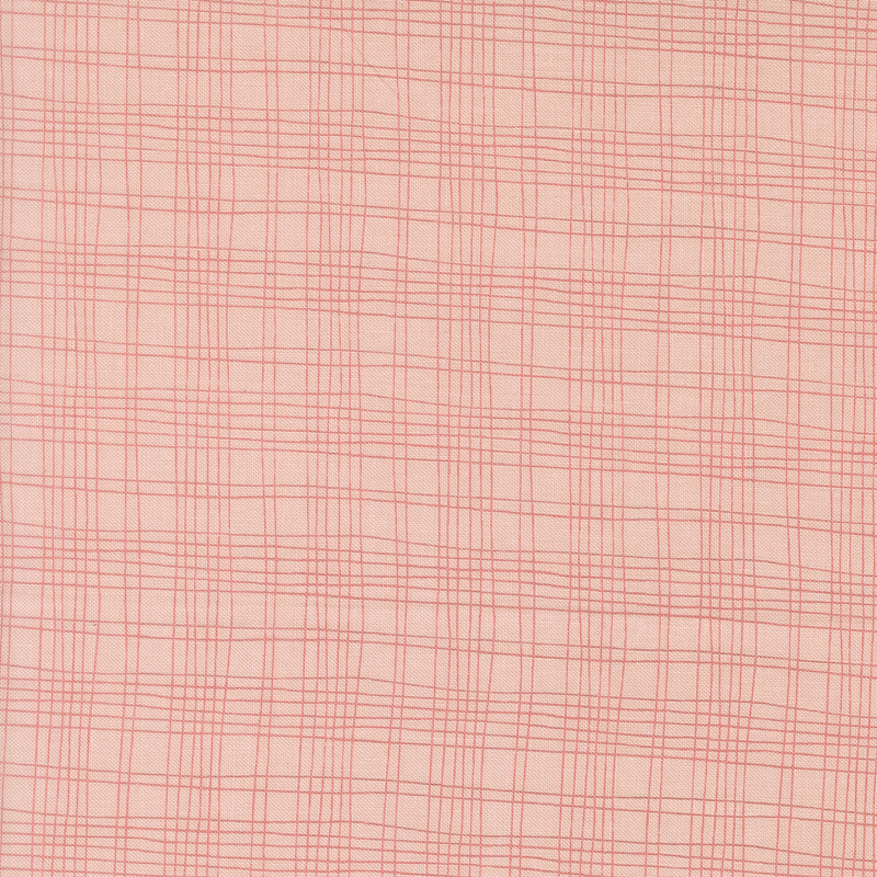 A blush pink fabric swatch featuring a free handed plaid pattern.