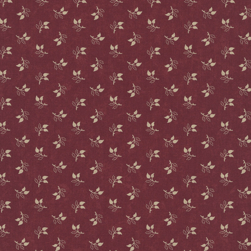 Mottled burgundy fabric featuring a tossed pattern of sprig leaves.