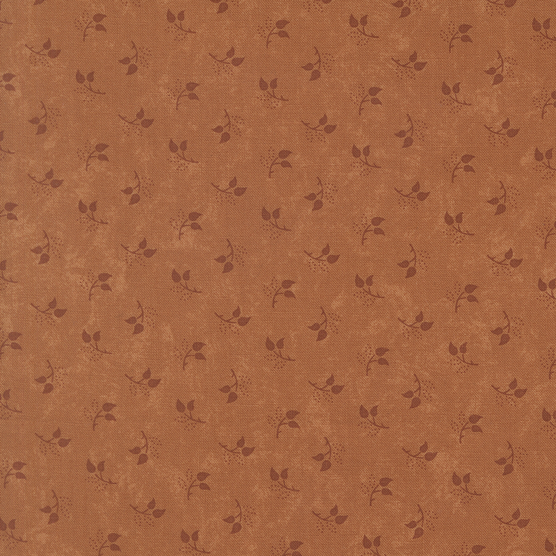Mottled burnt sienna fabric featuring a tossed pattern of sprig leaves.