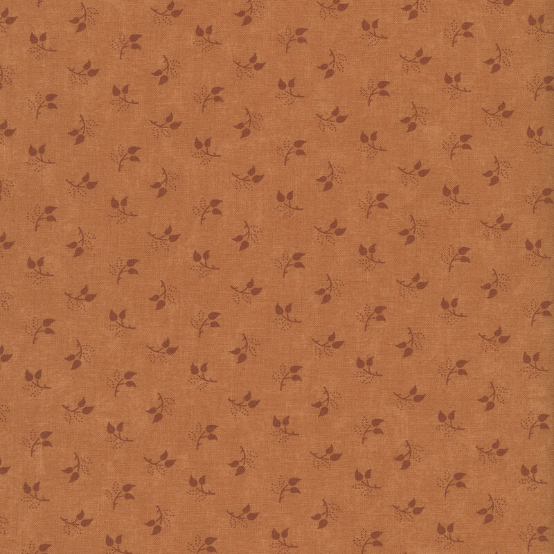 Mottled burnt sienna fabric featuring a tossed pattern of sprig leaves.