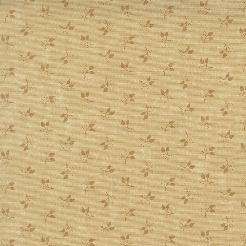 Mottled sand fabric featuring a tossed pattern of sprig leaves.