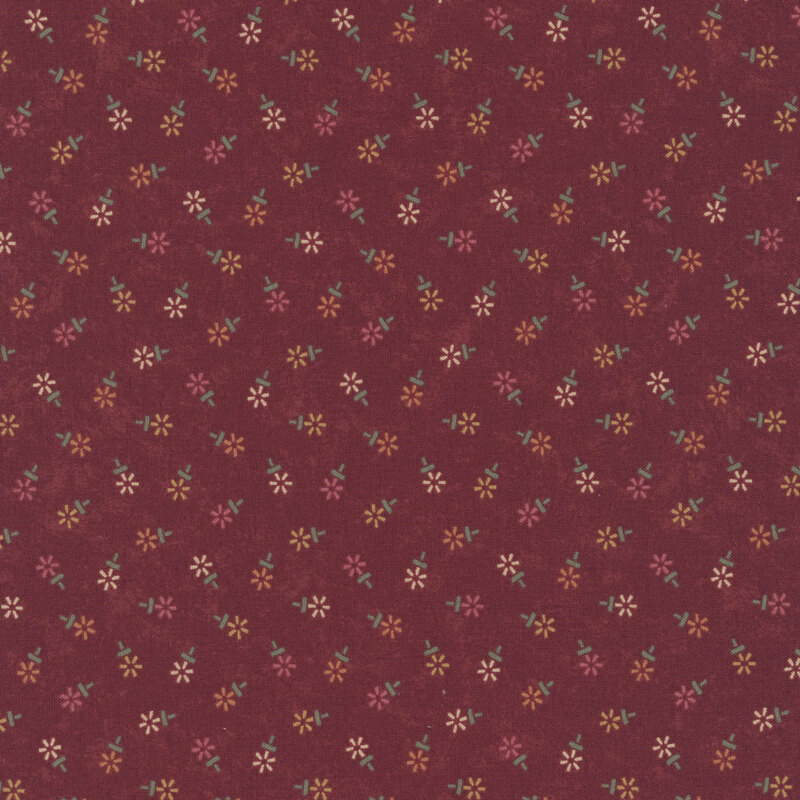 Mottled burgundy fabric featuring a tossed geometric floral print in hues of red, yellow, and cream.