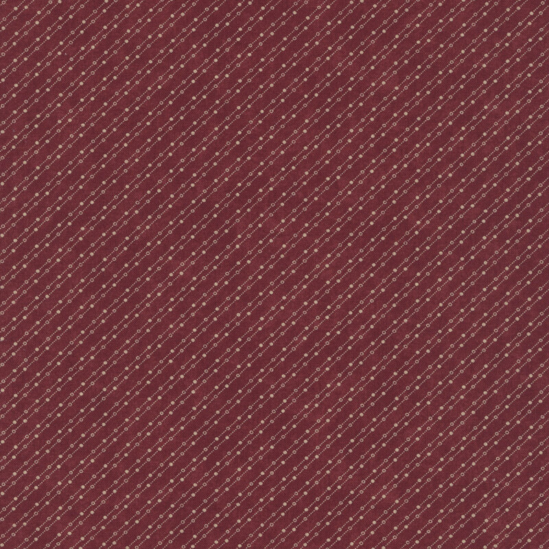 Mottled burgundy fabric featuring a stylized beaded-chain pattern in soft cream.