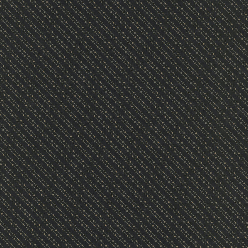 Mottled black fabric featuring a stylized beaded-chain pattern in soft cream.