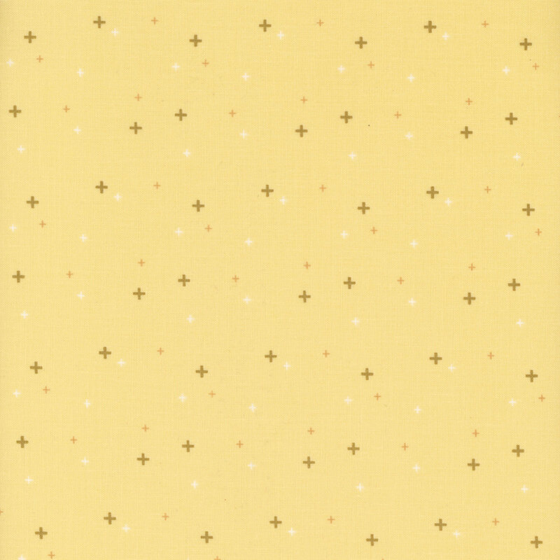 gold crosses scattered with yellow and white crosses on soft yellow fabric